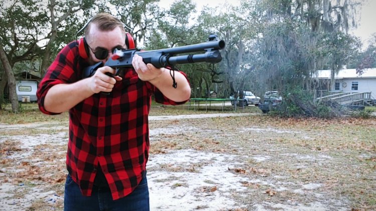 Author Travis Pike shooting gun