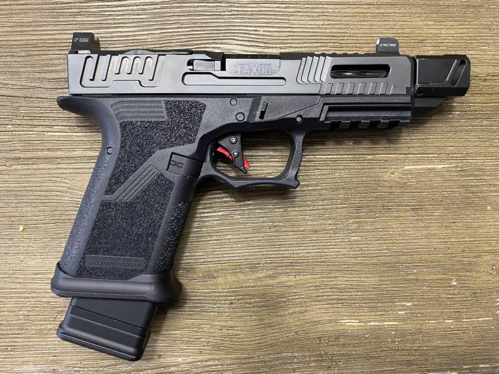 FX-19 Hellfire Pistol on wooden background